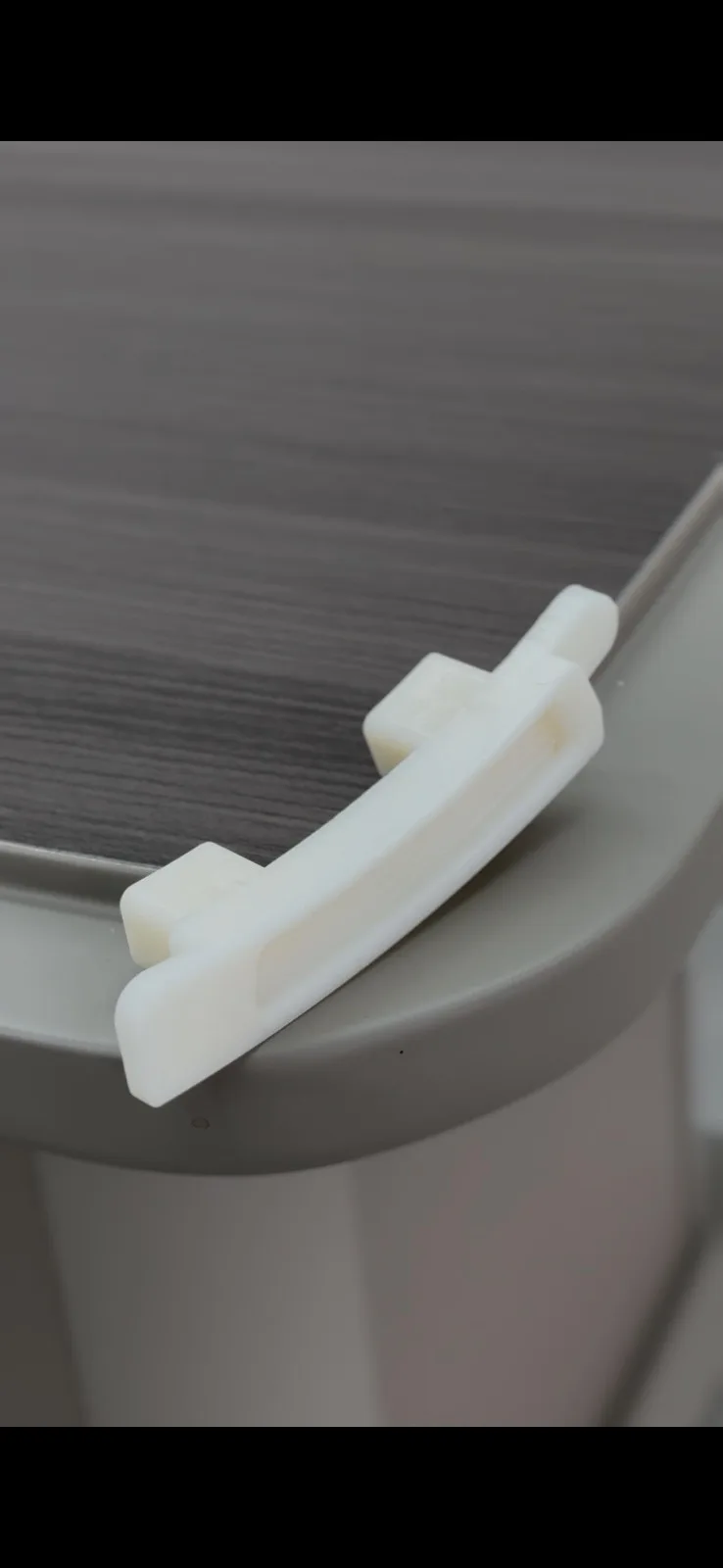 Close-up of a single arm-style ABS end cap
