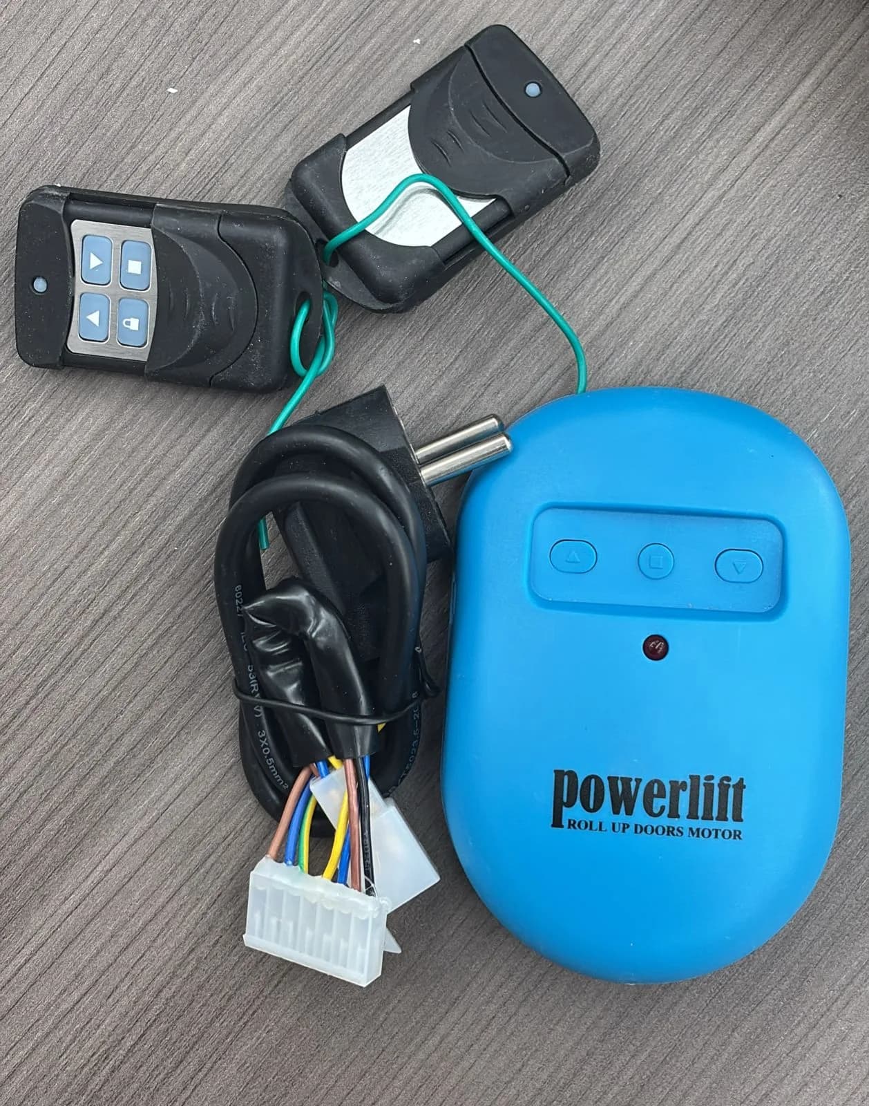 Roll-up door motor supplied with remotes and wiring harness